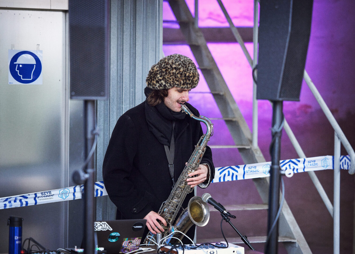 Saksofonista gra na instrumencie w budynku Szybu Staszic. 
